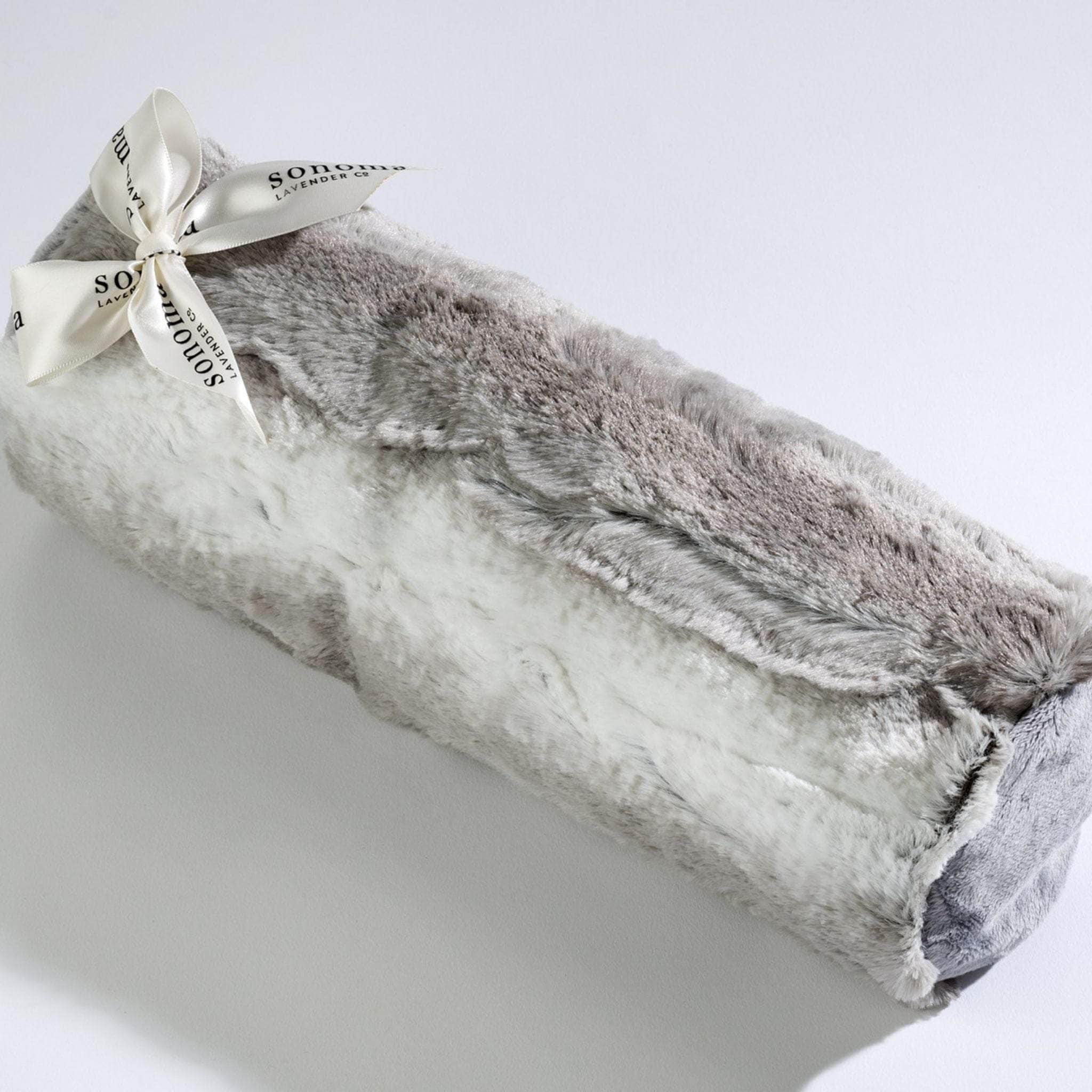 Luxuriously soft Platinum Angora bolster roll infused with calming lavender for soothing comfort and relaxation.