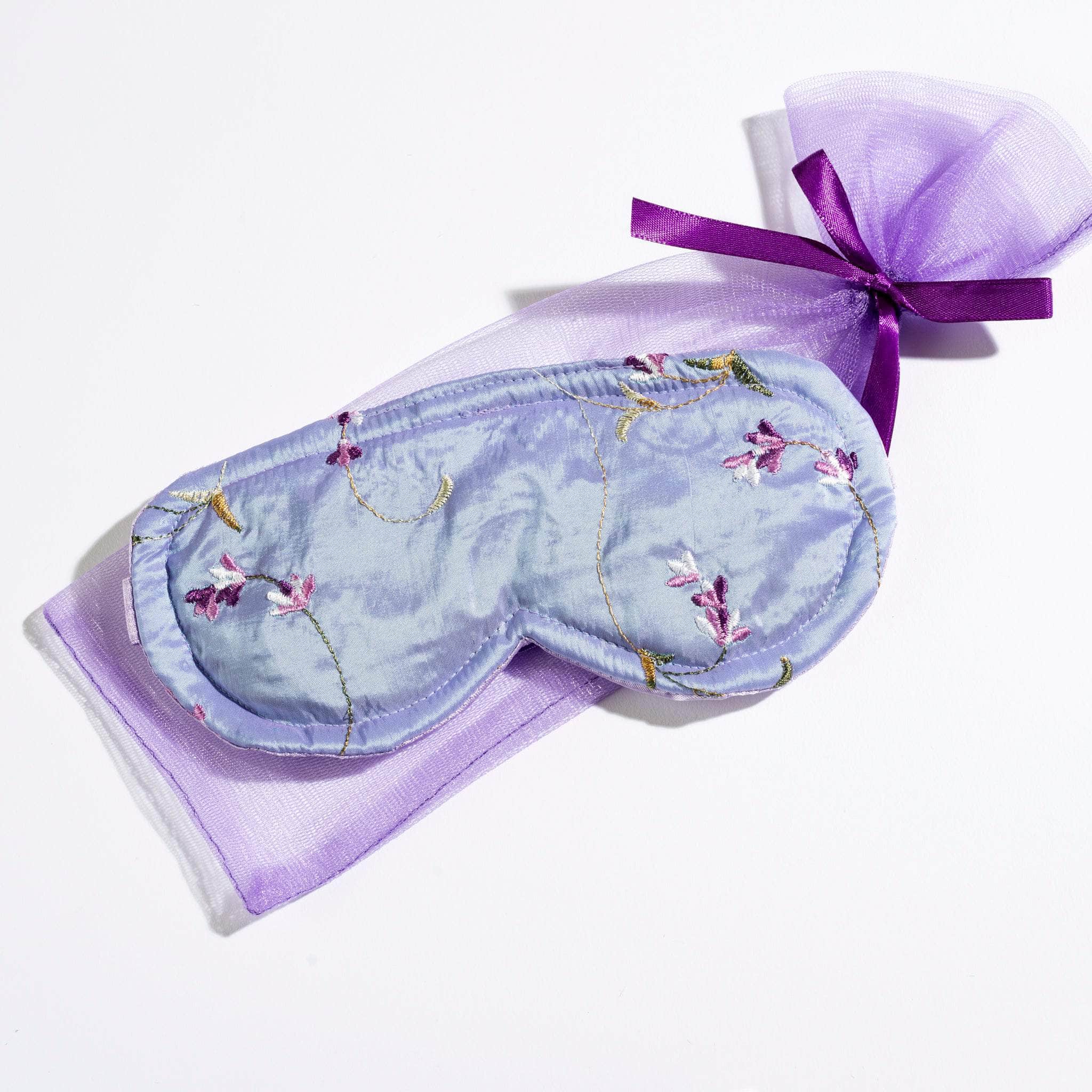 Luxurious embroidered satin Lavender Sleep Mask gently blocks out light, helping you relax and drift into a peaceful sleep with the calming scent of lavender.