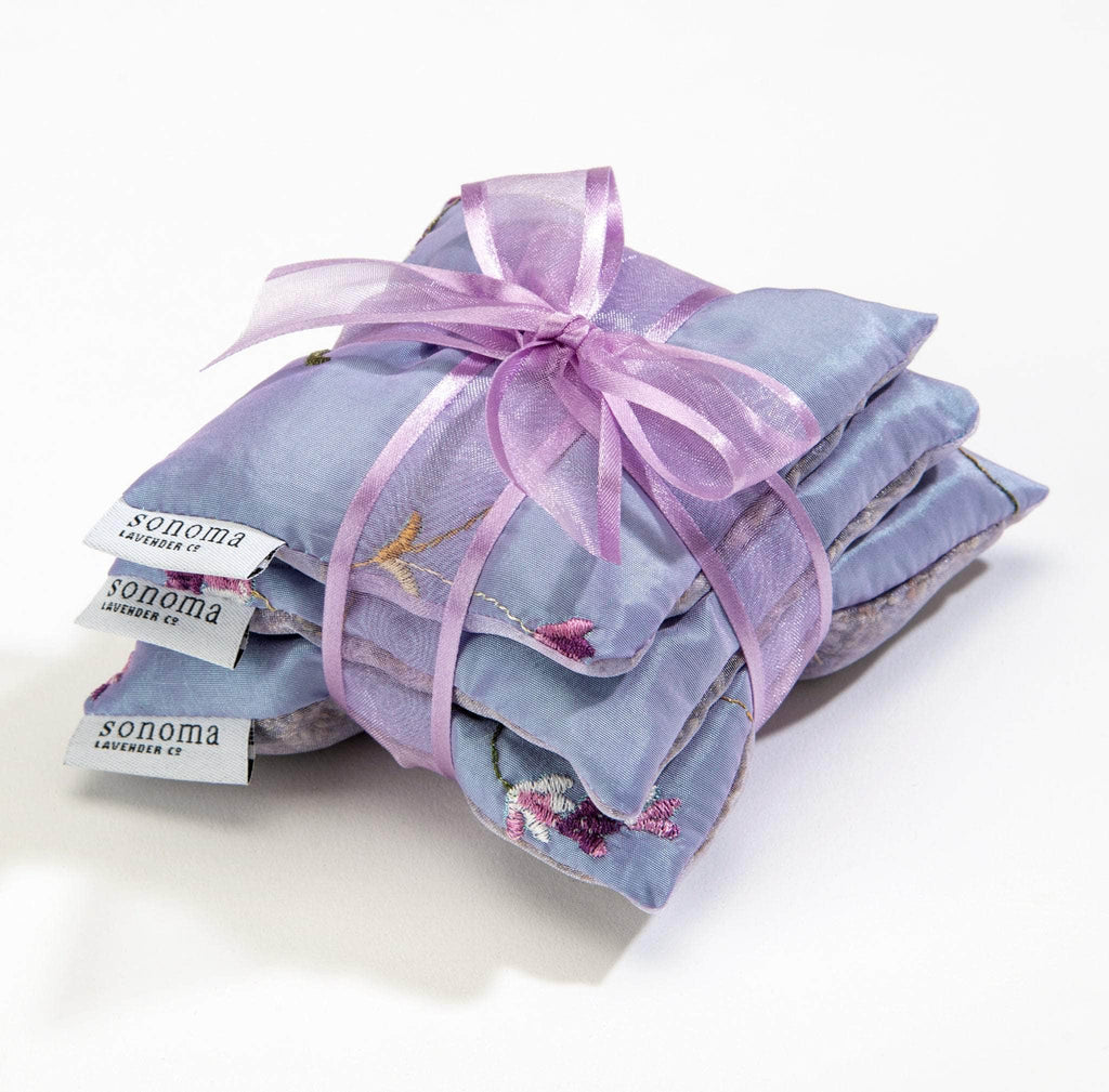 A beautifully embroidered Lavender Square Sachet Trio, filled with calming lavender to naturally freshen drawers, closets, and linens with a soothing scent.
